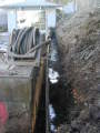 Trench behind retaining wall